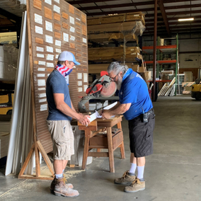 Pictured is a Durham Team member assisting a customer by cutting some material.